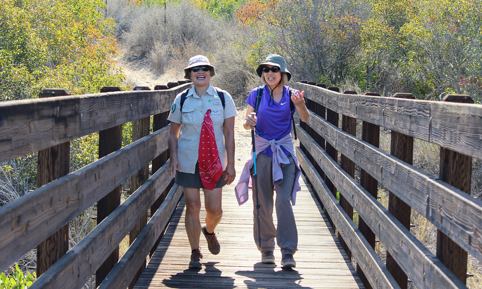 Maureen Li, left, and Jane Go chat as they hike through the Quail Hill open space preserve during a docent-led tour.