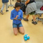 Girl controlling mini robot